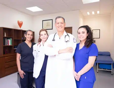 Medical professionals standing confidently in a clinic, showcasing teamwork and dedication to providing compassionate healthcare services.