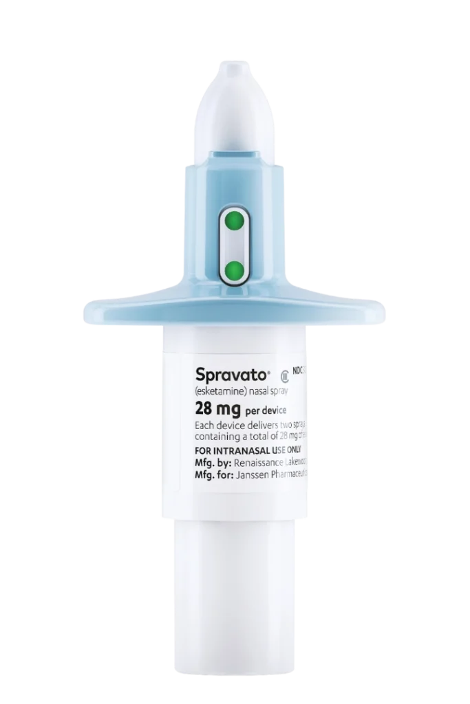 Spravato® (esketamine) 28 mg nasal spray device, designed for intranasal use. The white and blue applicator features two green indicators. © Janssen Pharmaceuticals, Inc. 2023.